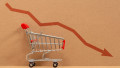 Empty grocery cart with the indicator of a falling economy. Concept of the economic crisis. Inflation. Food shortages, logistics problems.